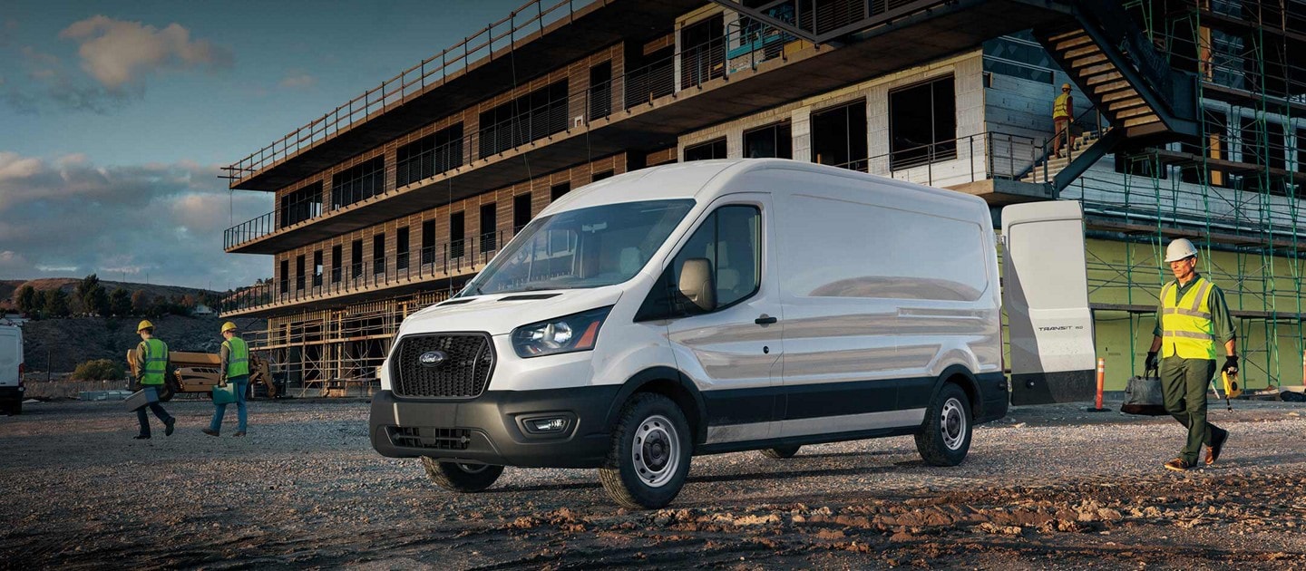 2025 Ford Transit® van parked in front of construction site with workers nearby