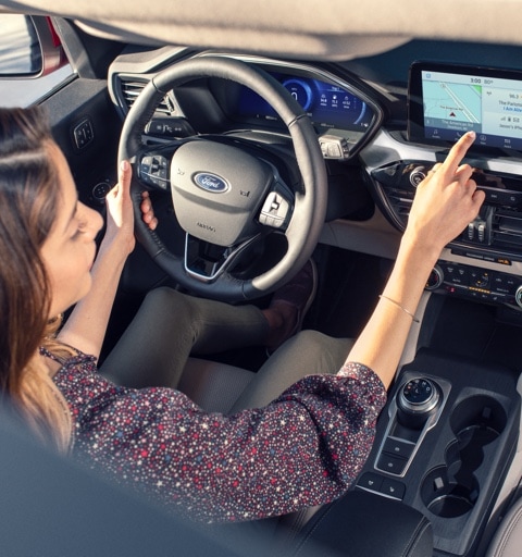 Female driver using touchscreen in the 2021 Ford Escape Titanium
